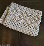 Handmade cream macrame clutch with tassel, textured fabric, one main compartment, zip closure, size: 20cm x 30cm. Colourful accessory for beach or casual outings, perfect for essentials storage. Made in India by skilled artisans