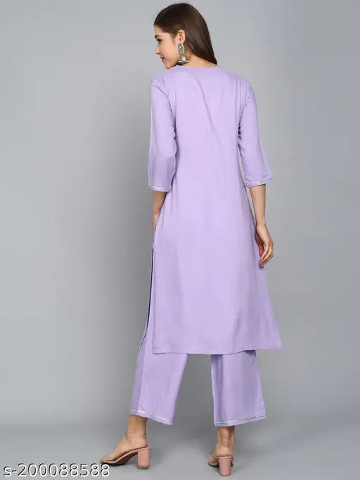 Lavender rayon embroidered kurta set with palazzos. Traditional sequin-embellished A-line design from ANGITA, perfect for functions, festivals, parties, and weddings
