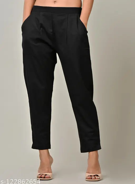 Black cotton solid trousers by Rakshita Fashions, ankle length with pleats detailing, side pockets, elasticated back, suitable for casual, daily use, office wear, and travel