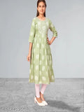 Green cotton Muhuratam Kids Floral Round Kurtis with three-quarter sleeves, printed net pattern, for 9-10, 10-11, or 15-16 years old. Indian kids clothing on display rack