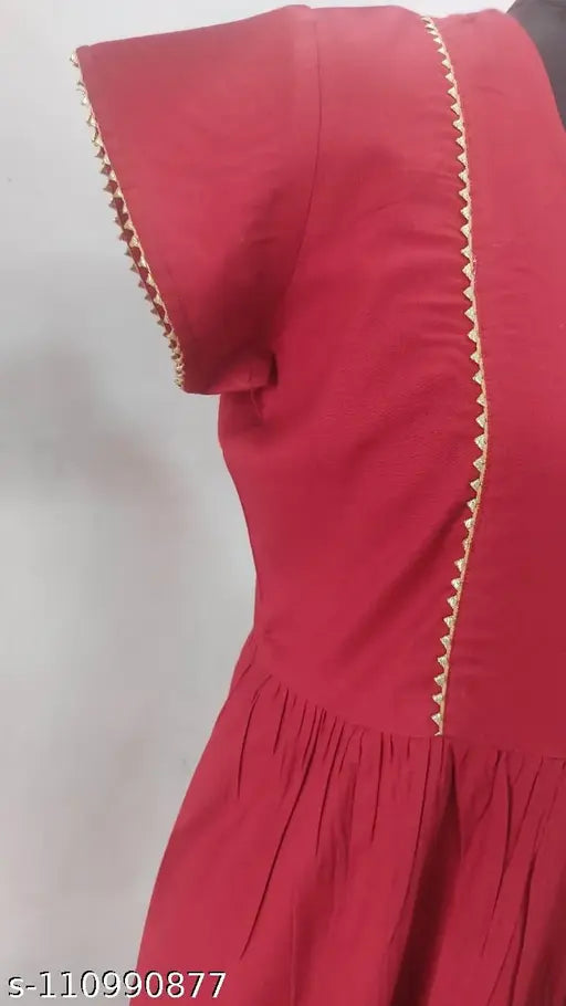 Maroon rayon flayered kurti, short sleeves, solid design. Gota lace detail on front and sleeves. S-40in, XS-32in, M-36in, L-38in. Indian handcraft