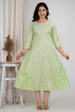 Rayon Anarkali-style Pista color kurtis with three-quarter sleeves and printed combo design, featuring chamaki print, zari embroidery, and samosa lace. Indian handcrafted women's and girls' fashion