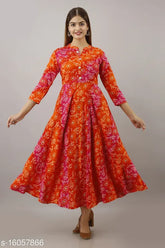 Orange rayon Anarkali embellished kurti with three-quarter sleeves, printed combo. Close-up of vibrant orange women's fashion kurti on hanger