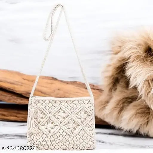 Handcrafted boho-chic macrame sling bag, intricate knots, fringe detailing. 100% natural cotton, perfect for everyday use or festival style. Made in India
