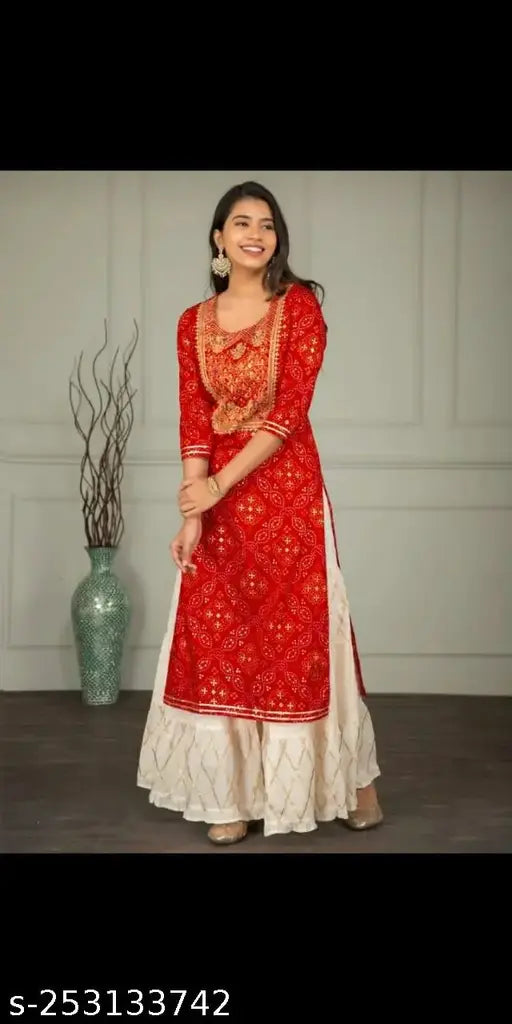 Rayon sharara set with printed net, three-quarter sleeves, Kurta and bottomwear in various sizes S-XXL. Indian traditional women's fashion on display