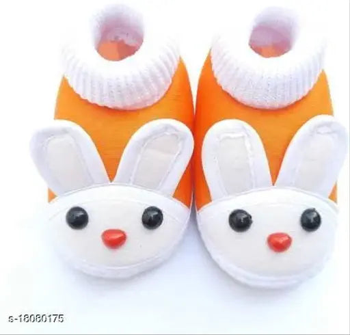 Stylish orange PU baby booties with velcro fastening and embellished net design. Comfortable footwear for 0-12 months, keeping feet protected in any season. Made from soft fabric safe for sensitive skin