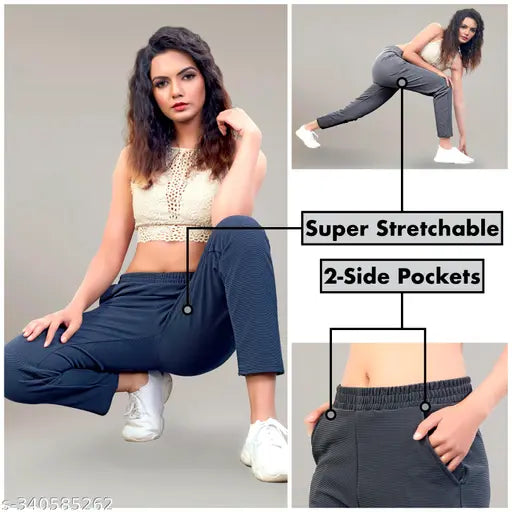 Black poly-cotton blend women's track pant combo pack with coordinated striped lining, soft fleece inner lining, and regular fit. 123 pieces in various sizes from 26-44 (waist 28-50 inches). Comfortable and stylish for daily wear or sports activities. India origin