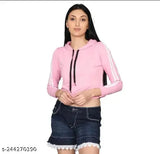 Pink cotton blend solid crop hoodie for women, stylish and trendy women's long sleeve crop top on display