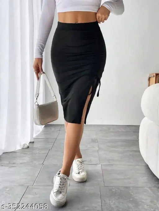 Black cotton blend pencil skirt for women, high waist, knee length, skinny fit, asymmetrical design with split thigh and drawstring detail. Size: 26 (waist 26in, hip 30in), 28 (waist 28in, hip 32in), 30 (waist 30in, hip 34in), 32 (waist 32in, hip 36in). Made in India