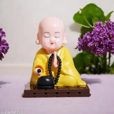 Solar-powered Buddha Monk Statue, moving head & hand - enhances health, wealth & prosperity. Plastic figure for car dashboard, home, or office desk decor. Ideal for travel memorials, housewarmings, or gift giving