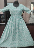 Women's green, cotton blend, calf-length fit and flare dress with three-quarter sleeves and printed combo. Available in sizes S to 4XL. Made in India