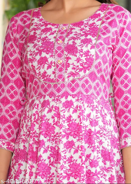 Pink rayon long-tiered embroidered yoke kurti with tassels, showcasing a vibrant printed combo. Sizes: S (36in bust), M (38in bust), L (40in bust), XL (42in bust), XXL (44in bust), XXXL (46in bust)