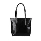 Black polyurethane textured croc shoulder bag with dual handles and zipper closure