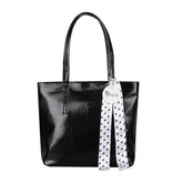 Black polyurethane textured croc shoulder bag with dual handles and zipper closure