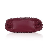 Red faux leather textured handbag with dual handle and zipper closure