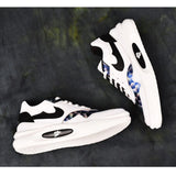 Black synthetic leather casual men's shoes on wooden surface, lace-up flat style for everyday wear