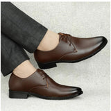 Brown faux leather men's formal shoes on wooden surface - versatile lace-up flat footwear for special occasions