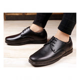 Men's black faux leather lace-up formal shoes on display