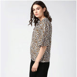 Orange & black animal print bell sleeve top on model, women's polyester fashion