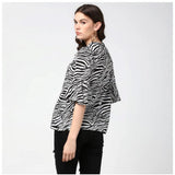 Black & White animal print bell sleeve top on model, women's polyester fashion with collar neckline