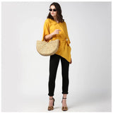 Yellow polyester solid cape sleeve top for women on display