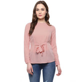 Pink polyester solid long-sleeve women's top on model, wearable for casual occasions