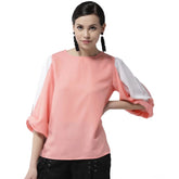 Women's pink polyester colour block slit sleeve top with round neck, vibrant fashion wear on mannequin