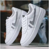 White synthetic lace-up sneakers for men, solid design on footwear rack