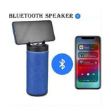 Blue plastic rubber wireless Bluetooth speaker (KT125), USB chargeable, on a charging stand
