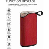 Red plastic rubber wireless TG111 Bluetooth speaker, USB chargeable home audio device on table