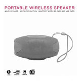 Grey plastic rubber wireless AO105 Bluetooth speaker, USB chargeable audio device on table