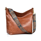 Brown PU leather medium sling bag with adjustable strap and zipper closure