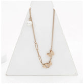 Gold-plated stainless steel butterfly pendant on delicate chain, close-up view