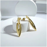 Women's gold plated mini office earrings, stainless steel with golden hue in professional setting