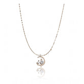 Gold-plated stainless steel women's moon pendant on delicate chain, close-up of jewelry detail