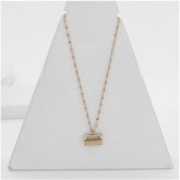 Gold-plated stainless steel mini suitcase pendant on delicate chain for women's accessories, close-up view