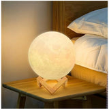 Multicolor plastic 3D moon night lamp on bedside table, illuminates room with captivating lunar design