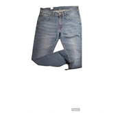 Blue cotton blended tapered jeans for men, mid rise with button closure on model