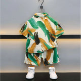 Multi-colored Lycra blend short sleeve shirt and shorts set for kids, featuring vibrant prints