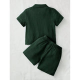 Green popcorn patterned boys' shirt-short set, solid short sleeve collar shirt and matching shorts on display rack