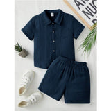 Navy popcorn solid short sleeve shirt and shorts set for boys, casual wear on display