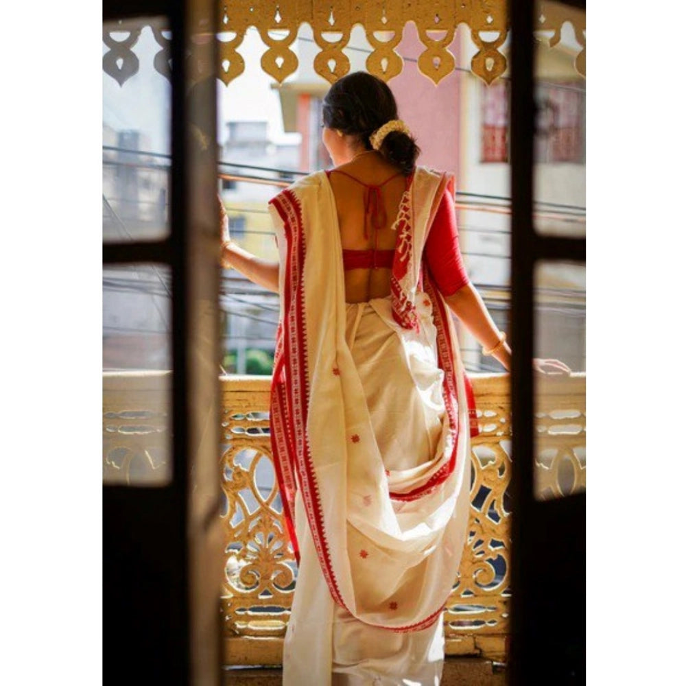 White cotton printed saree with unstitched blouse, vibrant design on display