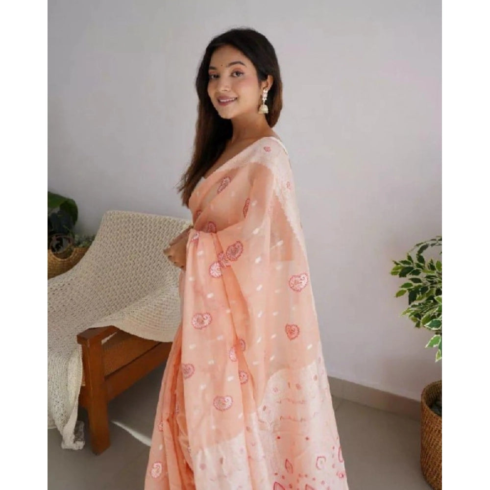 Women's peach cotton printed saree with unstitched blouse, vibrant floral pattern on display
