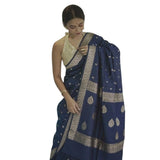 Navy blue cotton printed saree with unstitched blouse on mannequin, vibrant pattern details visible