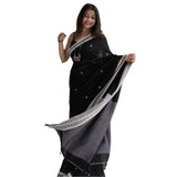 Black cotton printed saree with unstitched blouse, vibrant design on display