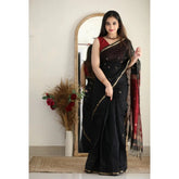 Black cotton printed saree with unstitched blouse, vibrant pattern on traditional Indian wear