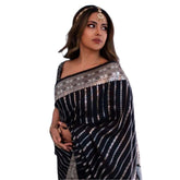 Black silk printed saree with unstitched blouse (5.5mtr) on mannequin, intricate pattern detailing