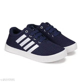 Navy blue canvas running shoe for kids, PVC sole, lace-up fastening detail on display stand