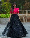 Black satin and net semi-stitched lehenga choli with embroidered patterns, latest Indian fashion wear for women