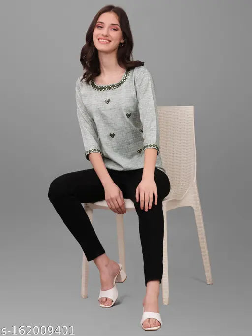 Green cotton blend mirror-worked top with three-quarter sleeves, embellished net pattern for festive and party wear, handmade in India